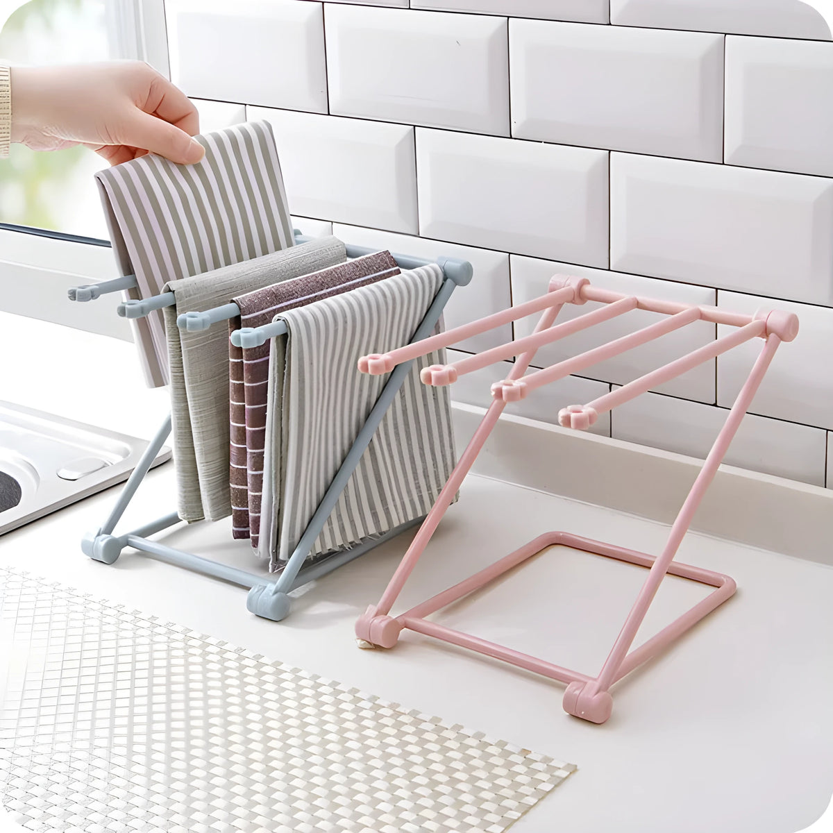 Foldable plastic dishcloth shelf organiser in Nordic style mounted on a kitchen wall