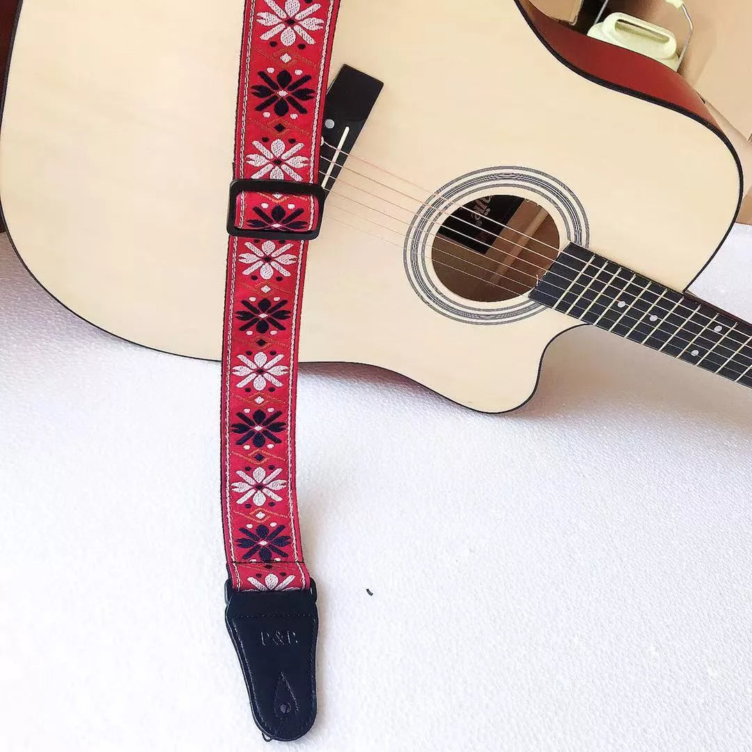 Adjustable embroidered guitar strap with durable webbing and intricate design