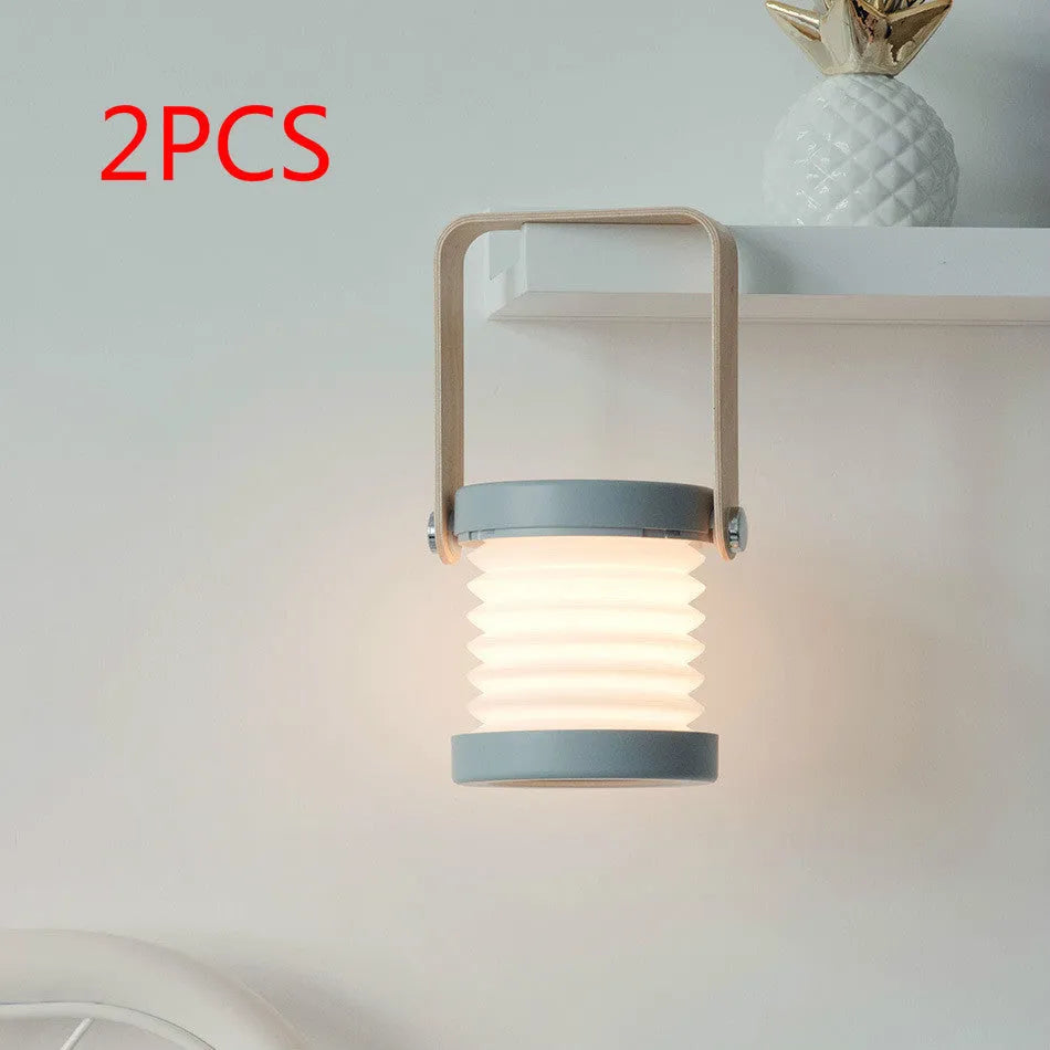 White foldable USB rechargeable LED night light in both table lamp and tall lantern modes.