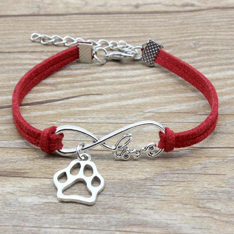 Hand-woven Infinite Love Pet Bracelet in various colors, showcasing the bow shape and alloy material.