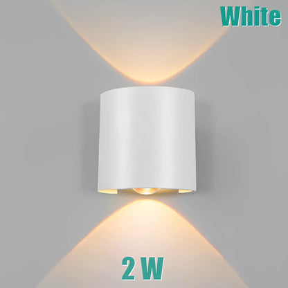 Waterproof black aluminium LED wall lamp 4W warm white emitting 60-degree beam angle mounted on white wall