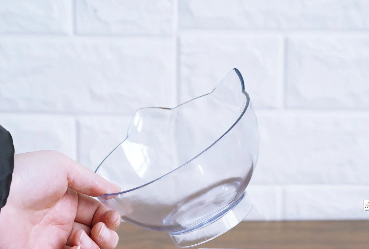 An inclined cat food bowl with a transparent design and a sturdy base, providing a comfortable and hygienic dining experience for your feline friend.