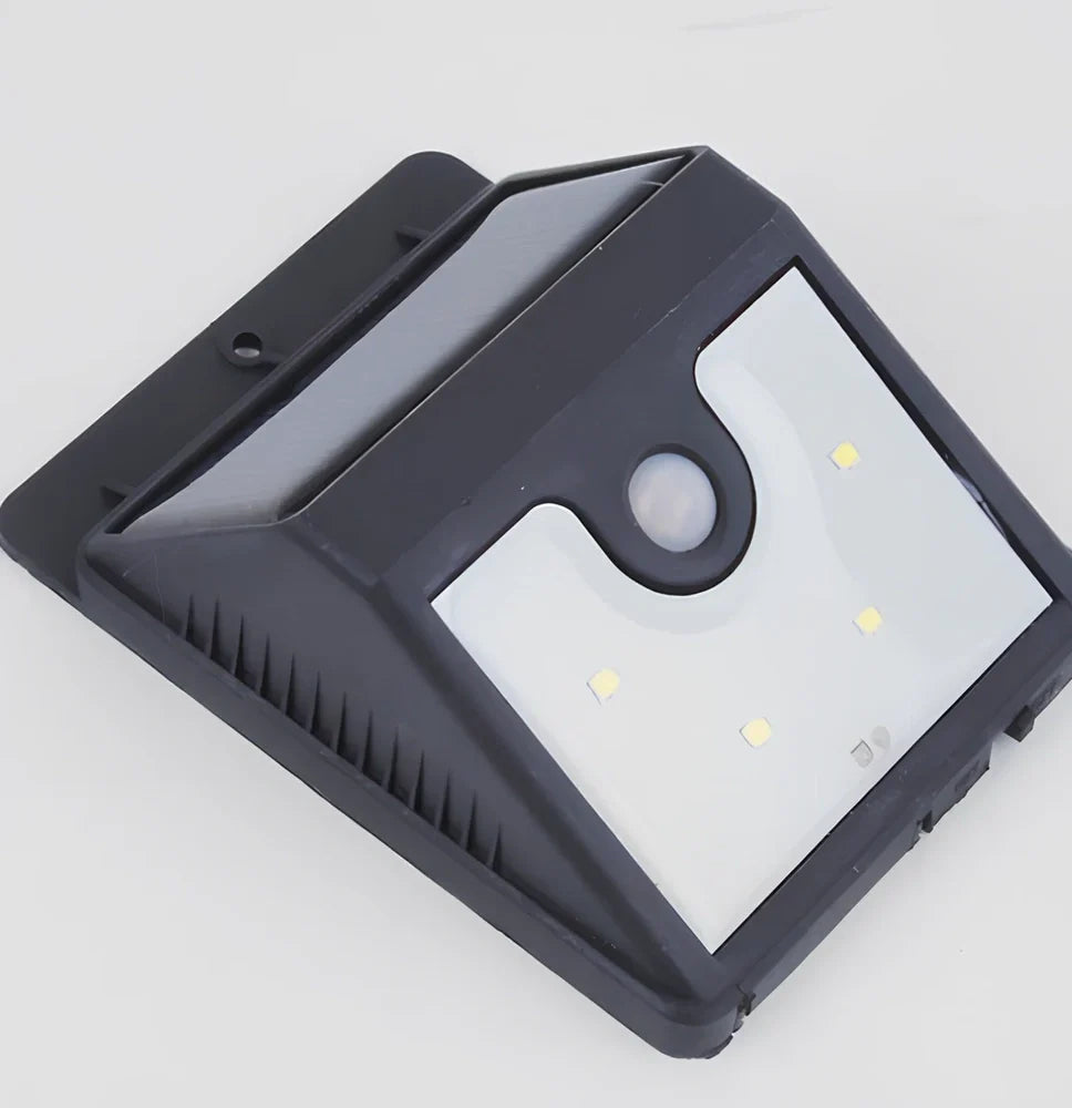 Solar 4 LED sensor lights mounted on garden wall, showing motion detection range and bright illumination at night