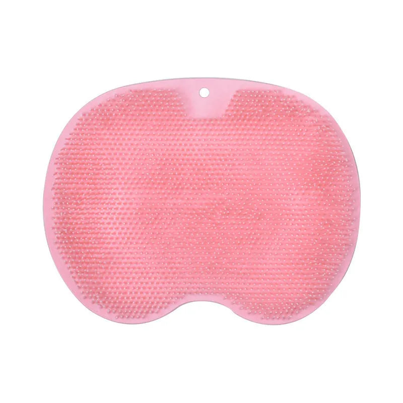 Orange non-slip massage bath brush with silicone bristles and suction cup base on shower floor