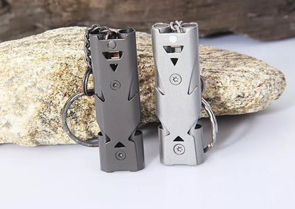 Durable metal keychain whistle in silver and black, compact design for safety