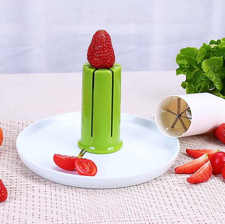 White plastic vegetable and fruit slicer with six stainless steel blades for cutting cucumbers and carrots.