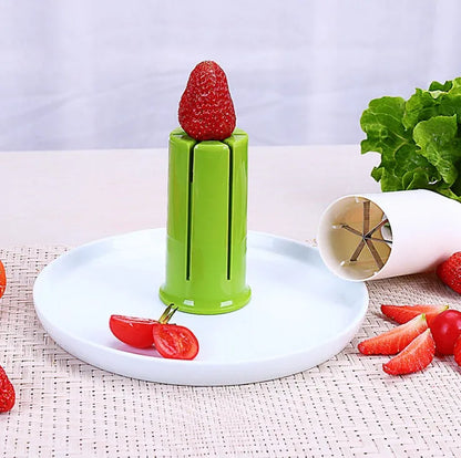 White plastic vegetable and fruit slicer with six stainless steel blades for cutting cucumbers and carrots.