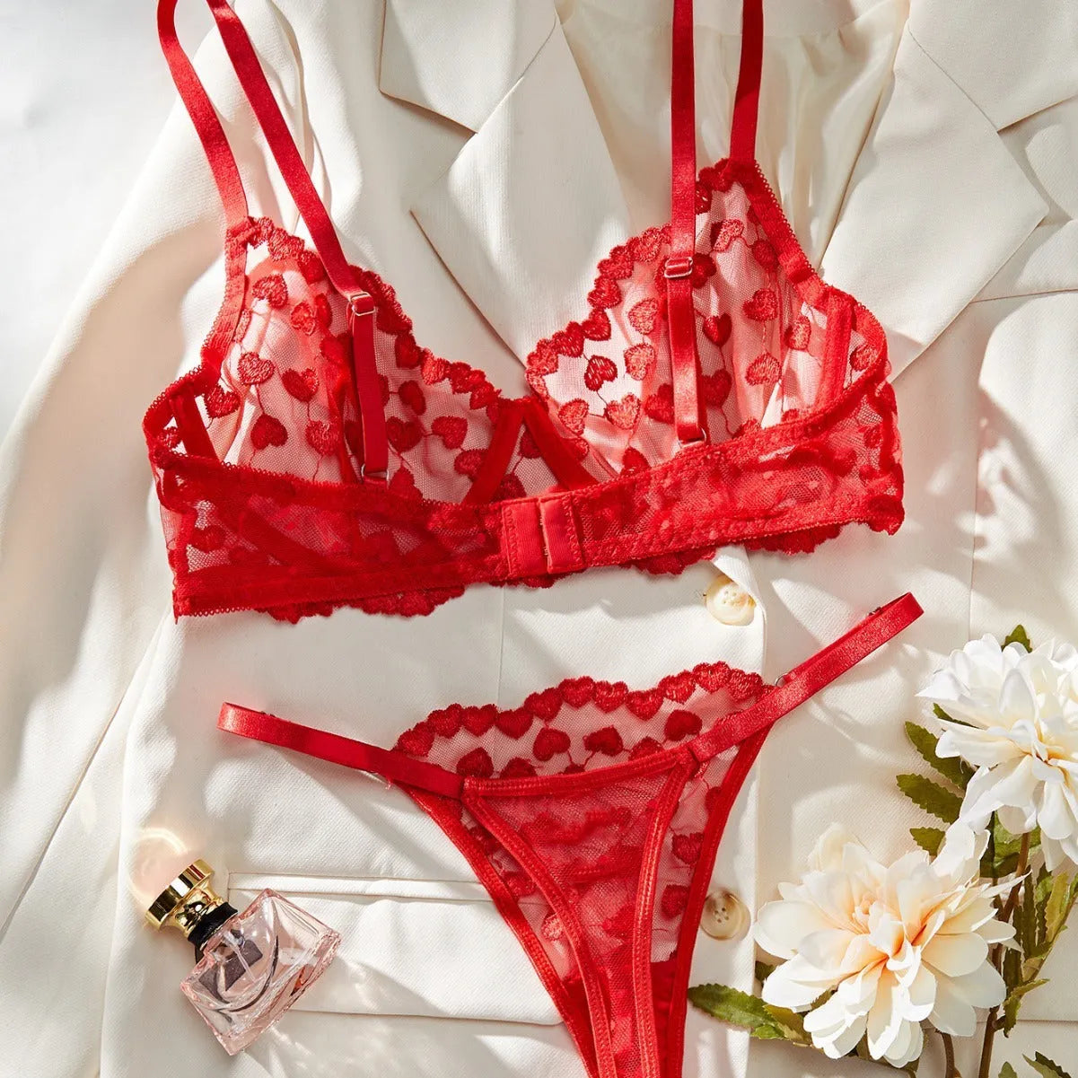 Romantic multi-colour mesh women's suit set comprising a top and trousers, shown in red and black colour options.