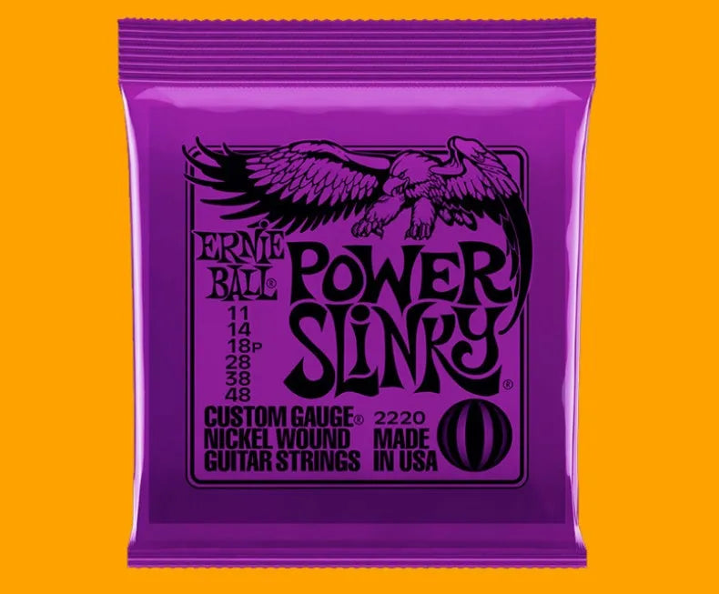 Coils of nickel-plated electric guitar strings and bass strings showing their metallic shine.