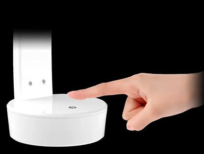 White folding LED desk lamp with touch control on wooden desk