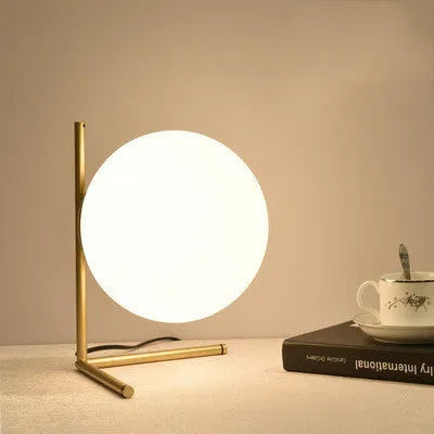 Creative glass table lamp with LED light in one of three available sizes for a living room or study