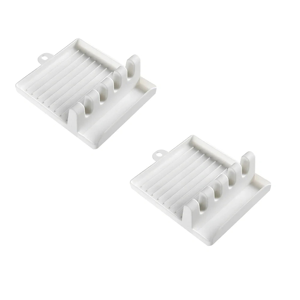 Green silicone spatula holder with four slots for kitchen utensils on countertop