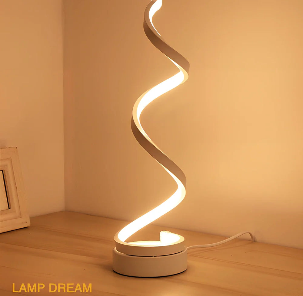 Modern table lamp with curved design, metal base, and acrylic shade offering remote-controlled dimming between warm and white light