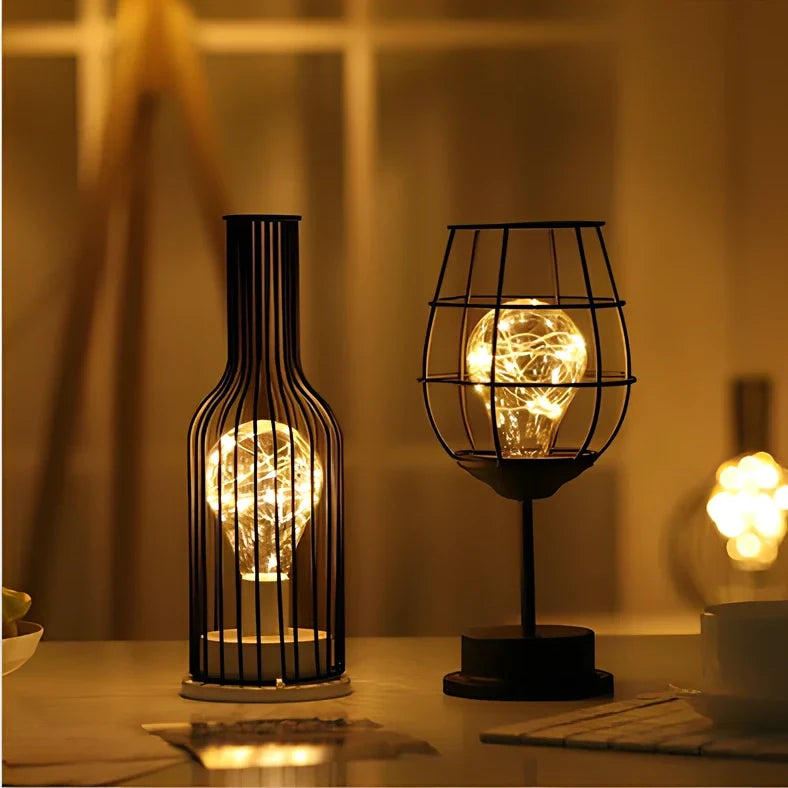 Minimalist hollow table lamp in red wine bottle design with wrought iron construction and warm white LED illumination