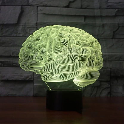 3D brain-shaped LED lamp with colour changing modes and remote control on wooden surface
