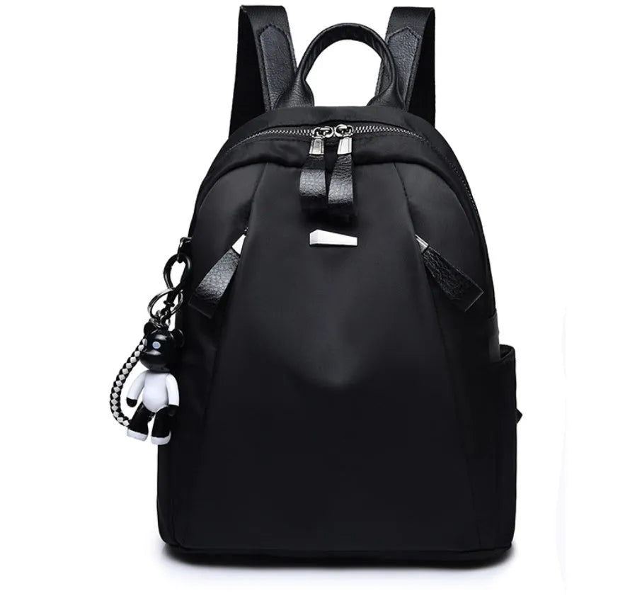 Medium square rucksack in Oxford cloth with two straps and a soft handle, shown in wine red.