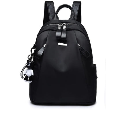 Medium square rucksack in Oxford cloth with two straps and a soft handle, shown in wine red.