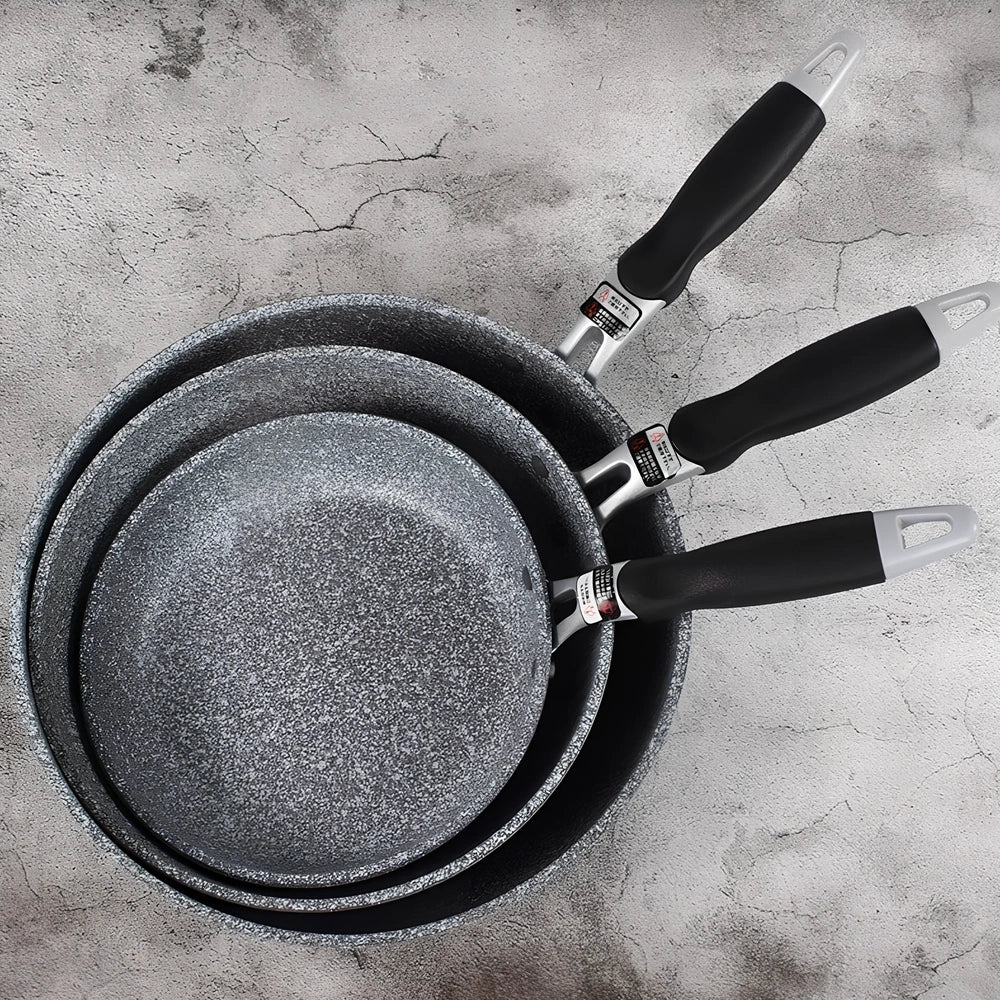 Japanese-style Maifan stone frying pan with glass lid showing non-stick surface and compound bottom