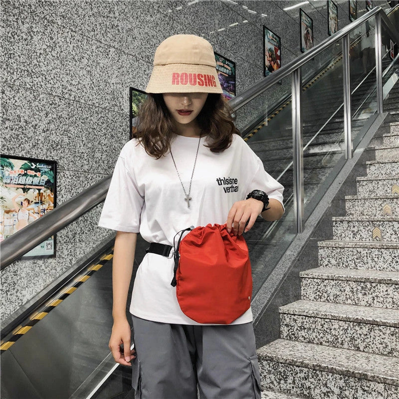 Stylish nylon drawstring waist bag in various colors for hands-free convenience and fashionable everyday carry