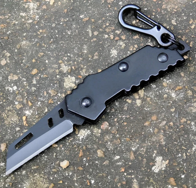 Black pocket folding knife with serrated blade, 85mm length, stainless steel handle