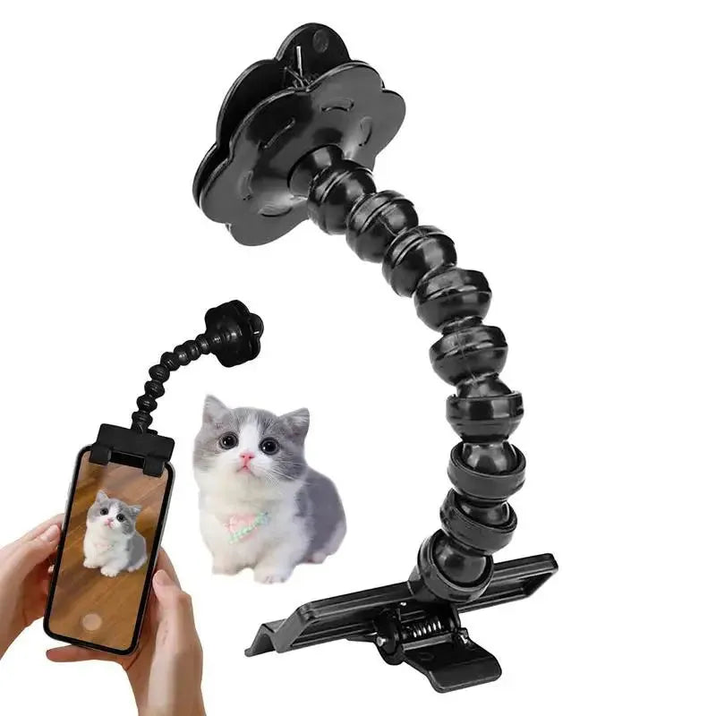 Black plastic pet photography tool attached to mobile phone with treat clip extended