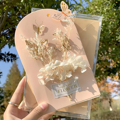 Handmade 3D pop-up greeting card with butterfly shape showing artificial flowers and hot stamping details