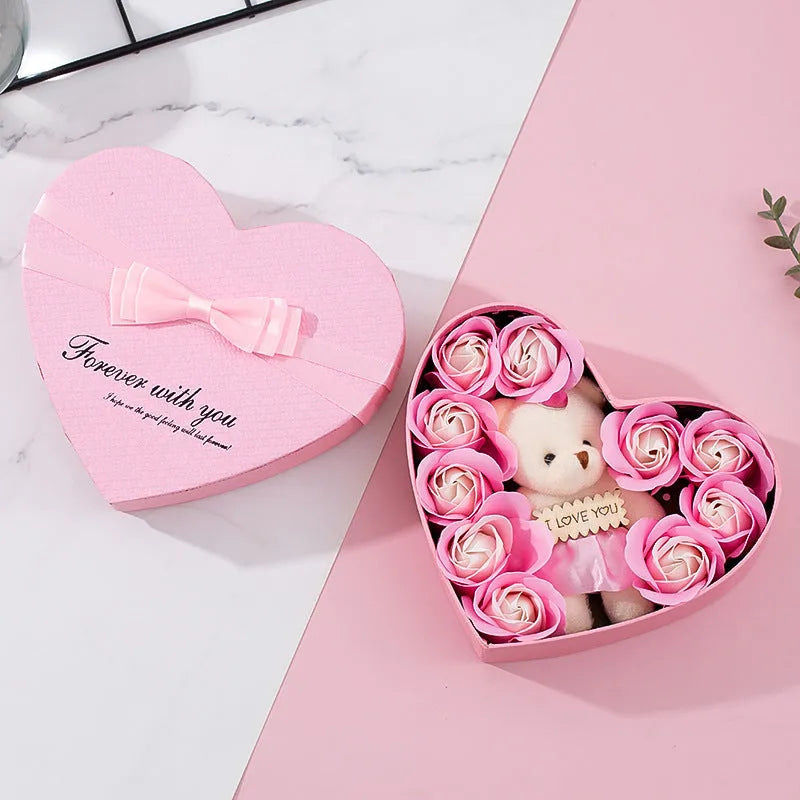 Red heart-shaped gift box open to reveal soap roses inside.