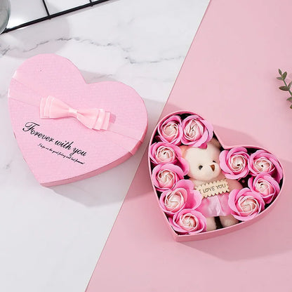 Red heart-shaped gift box open to reveal soap roses inside.