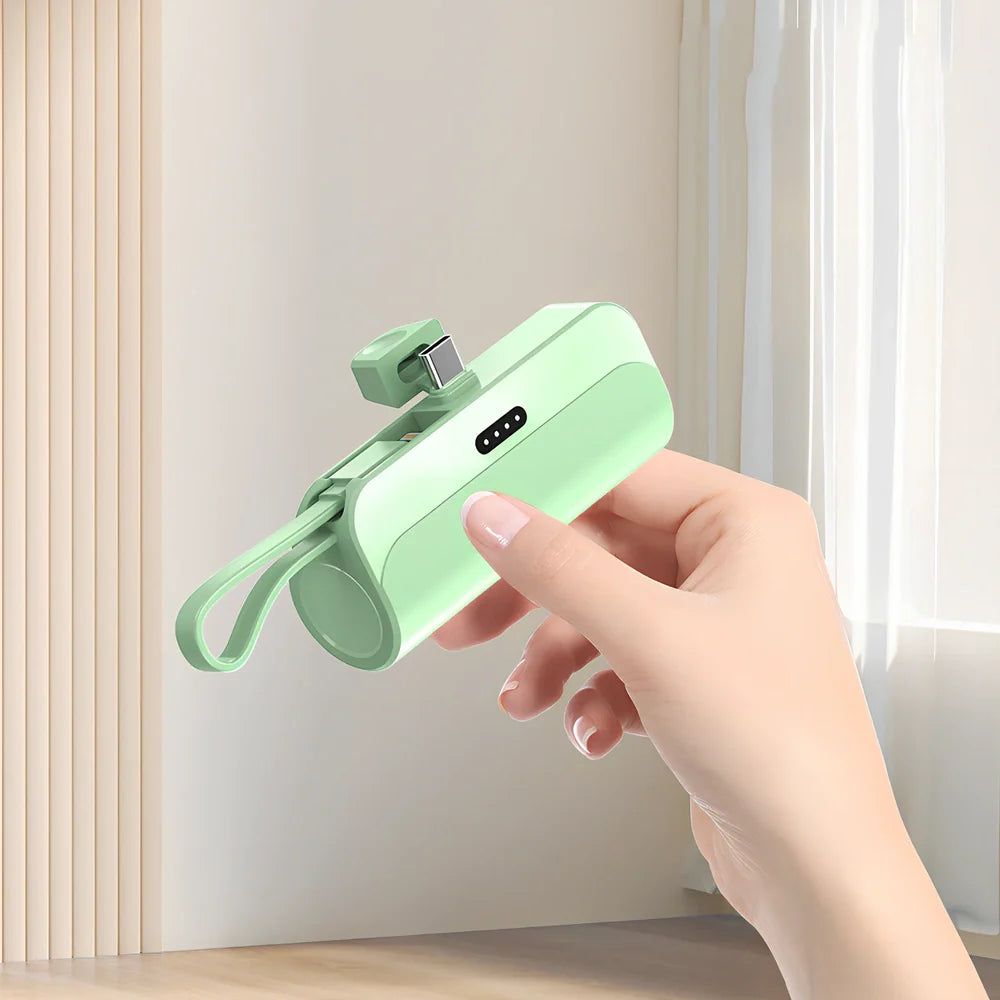 White capsule power bank showing compact 79mm size with USB charging ports visible