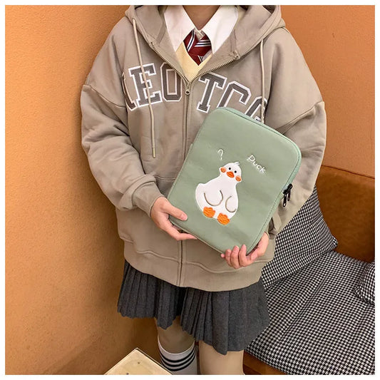 Blue tablet case with embroidered cartoon duck design showing zipper closure and cotton fabric texture