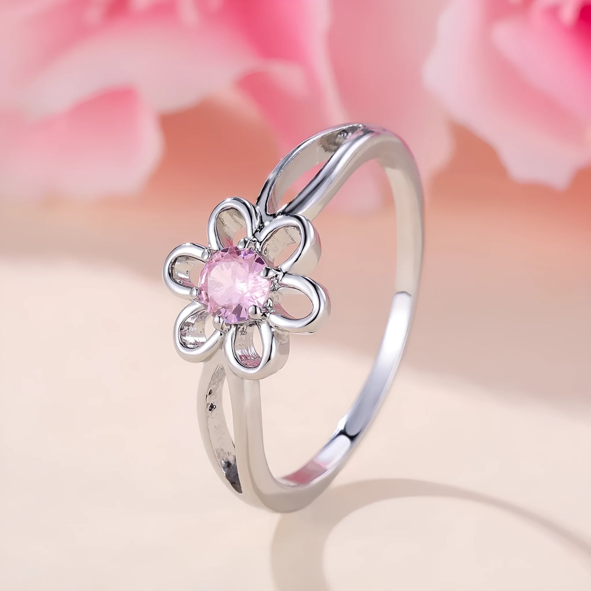 Women's hollow flower design fashion ring in electroplated copper with a platinum pink diamond finish.