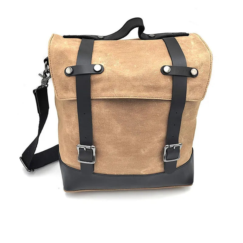 Black waterproof canvas motorcycle side bag with cowhide accents showing mounting straps