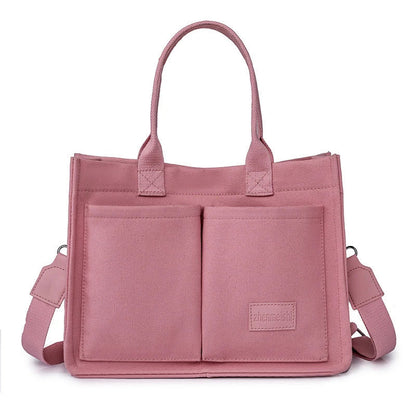 Premium canvas tote bag in multiple colors with adjustable shoulder strap and organizational pockets