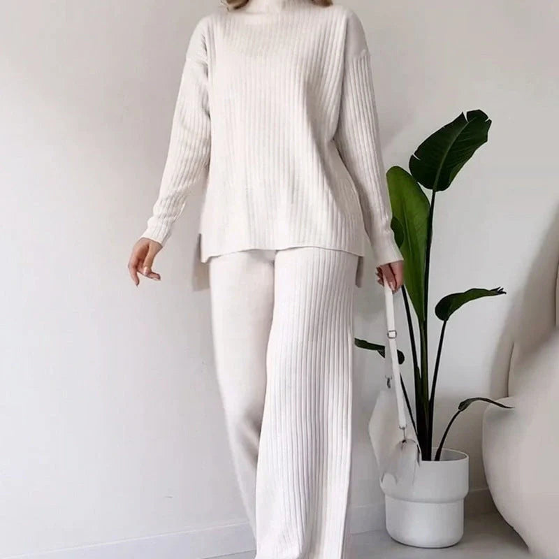Women's turtleneck knitted suit set with loose split design and straight trousers in white, black, and green