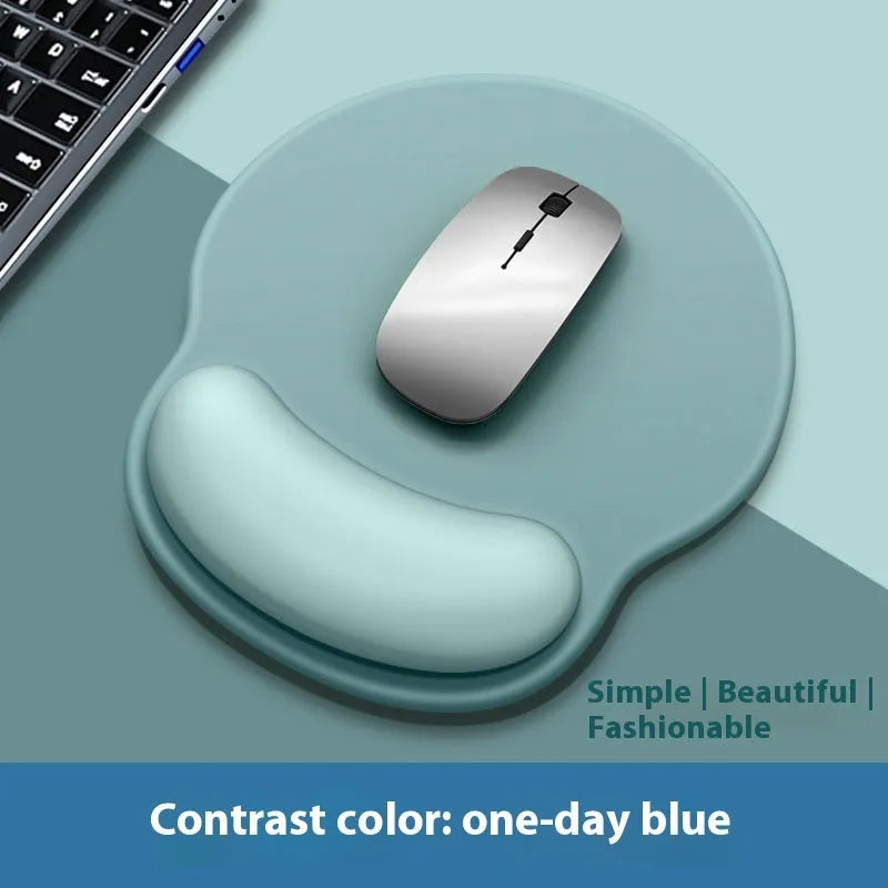Silicone mouse mat with wristband in a gradient blue black colour pattern on a desk.