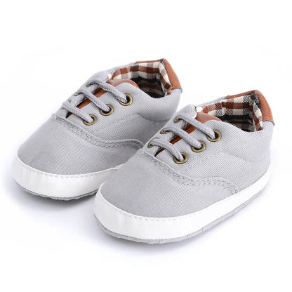 Baby canvas shoes in solid colour with soft bottom and front strap, sizes 11cm to 13cm
