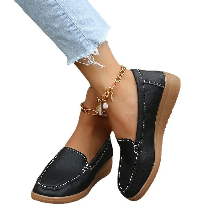 Women's flat shoes with car suture detailing on PU leather upper, round toe, rubber sole, available in multiple colours