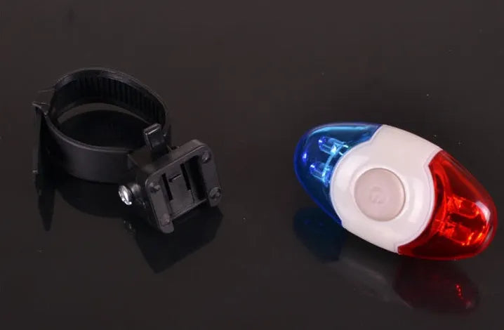 Red and blue LED bicycle tail light with adjustable mounting base showing horizontal and vertical positioning options
