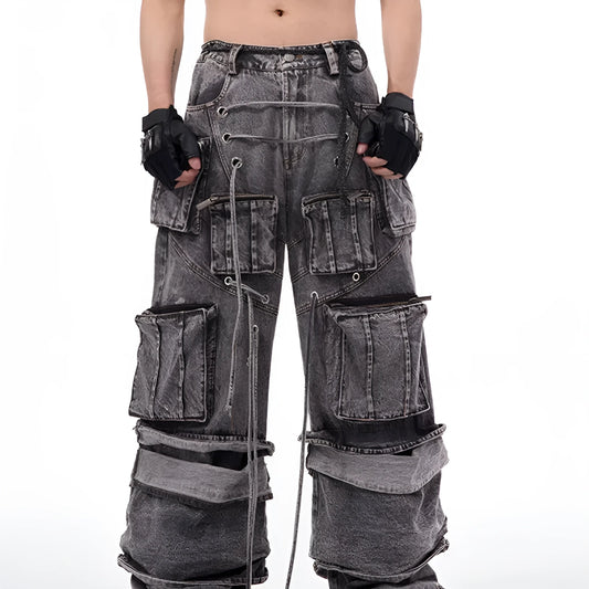Grey distressed denim overalls with rope stitching on a man, showcasing the mop pant style.