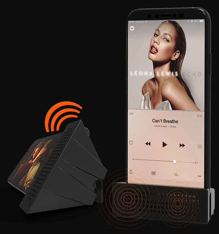 Portable black ABS plastic phone amplifier bracket holding a smartphone on a desk.