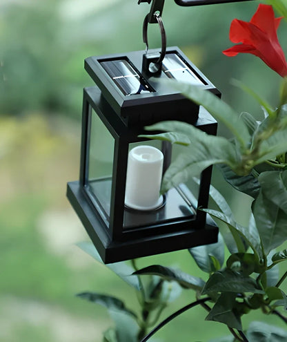 Black solar candle lamp with warm white LED illumination for outdoor gardens and patios