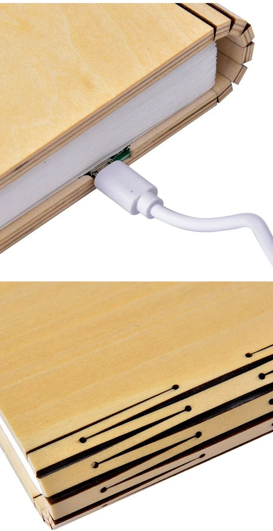 LED book lamp with wooden cover open at angle showing illuminated pages and USB cable