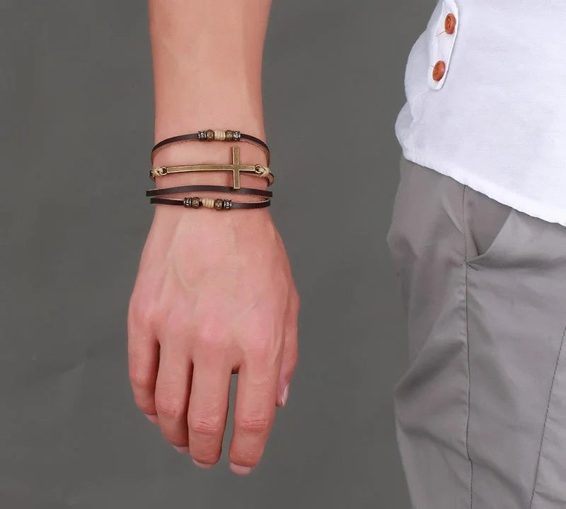 A handcrafted leather bracelet featuring a cross design, perfect for adding a touch of rustic style to any outfit.