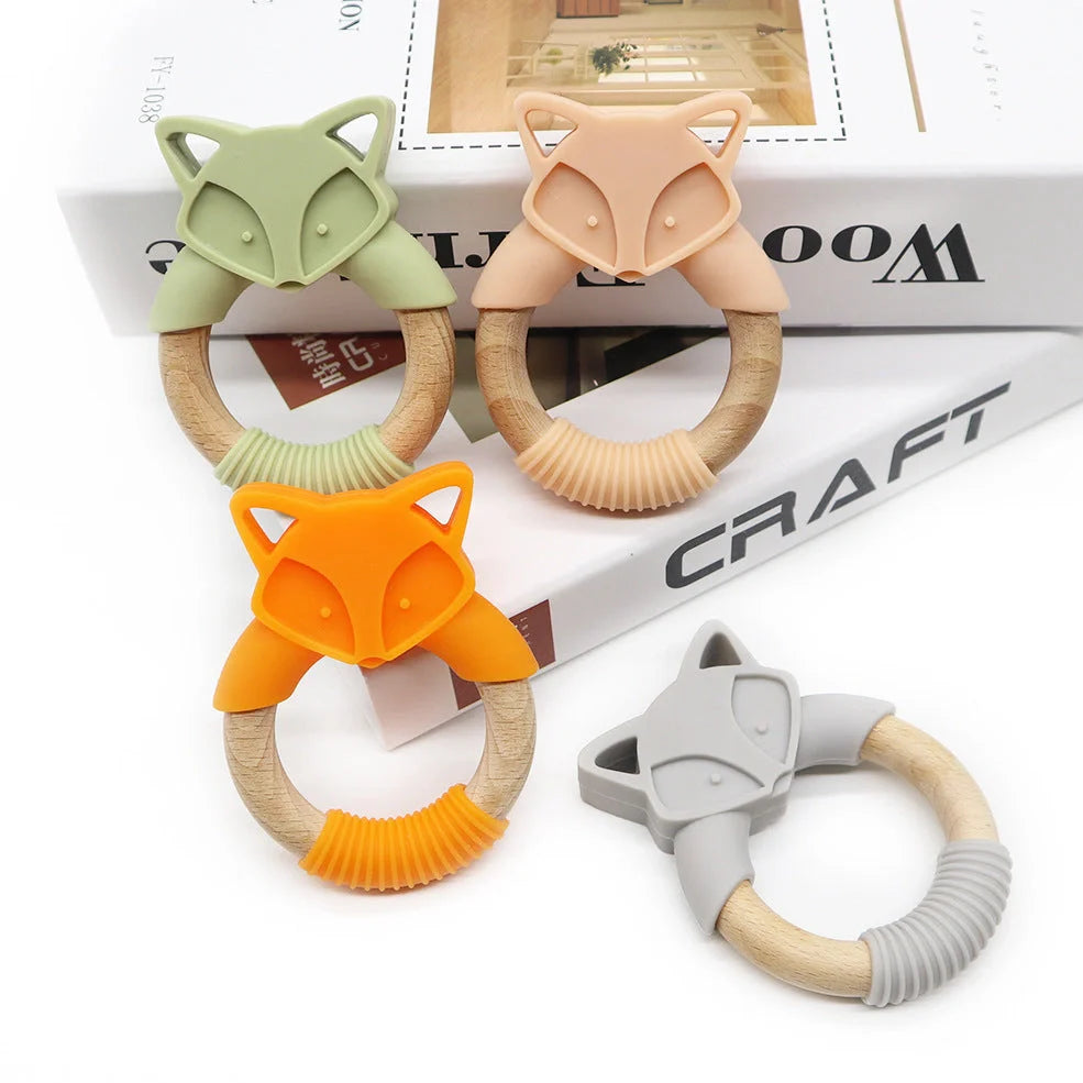Wooden fox teether with orange silicone ring measuring 80mm high