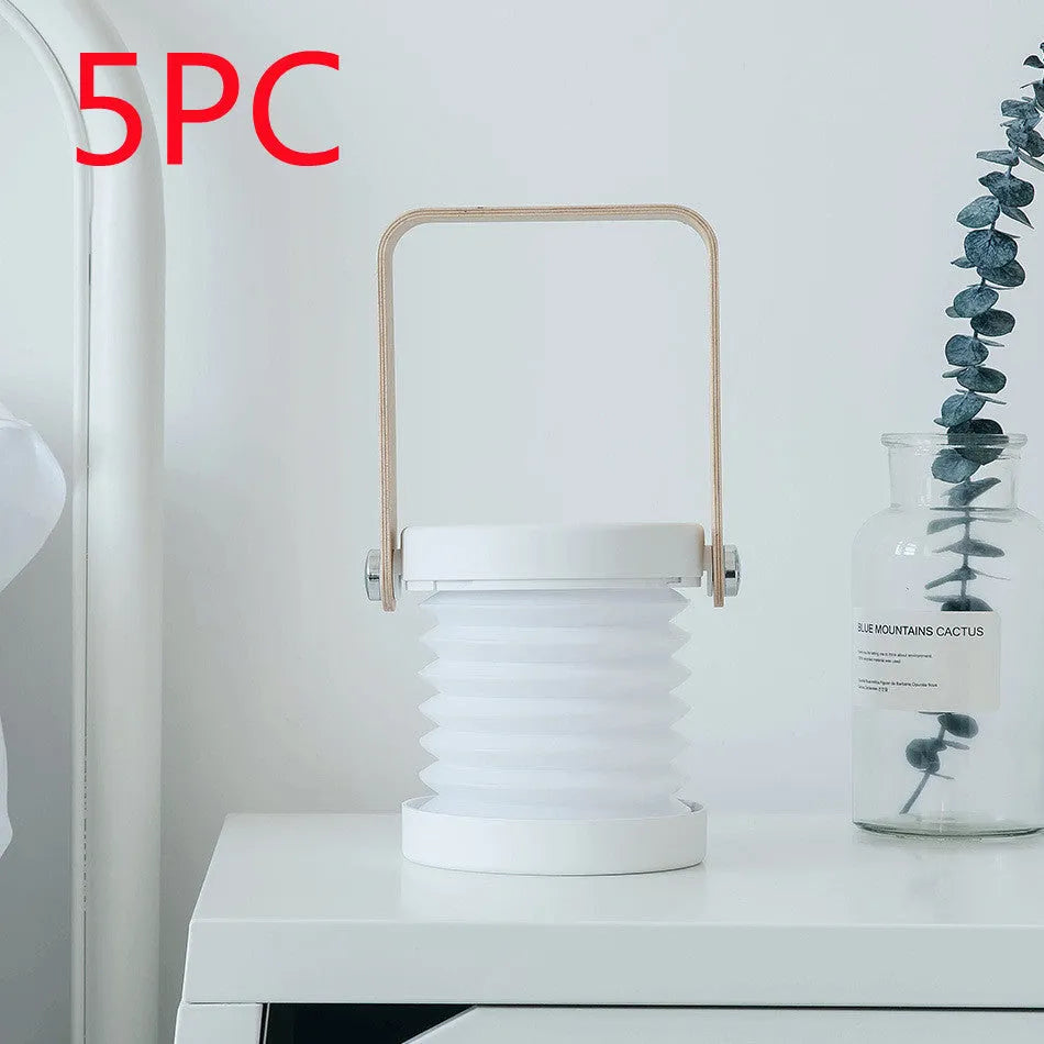 White foldable USB rechargeable LED night light in both table lamp and tall lantern modes.