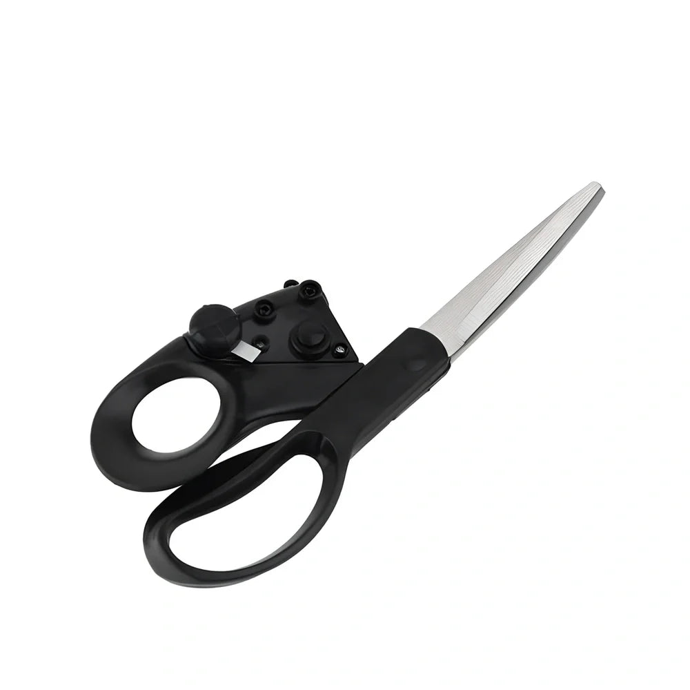 Black laser-guided scissors with red beam cutting straight line on wrapping paper