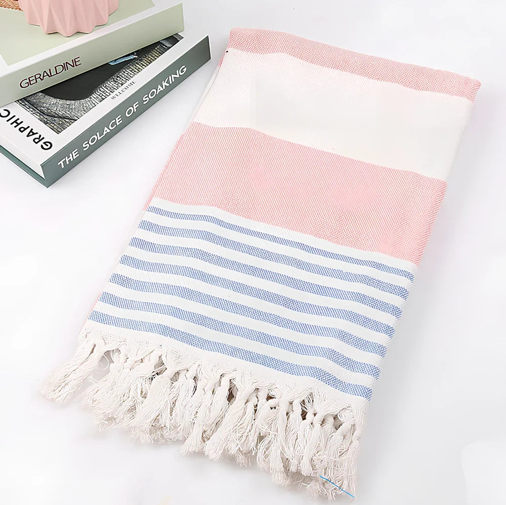 Striped Turkish beach towel showing blue and white pattern, measuring 100cm by 180cm