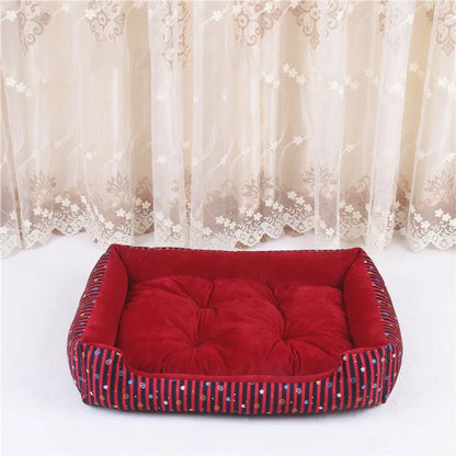 Oval cloth pet bed for dogs or cats in a striped colour pattern, showing its soft cushion shape.
