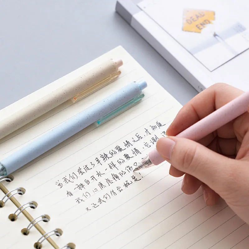 Set of 12 coloured 0.5mm gel pens with black ink and press-button tops on a white surface.