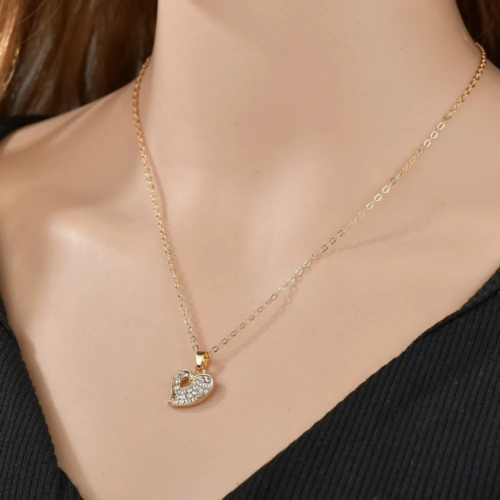 Gold-coloured women's love jewellery set with earrings, pendant and bracelet featuring bell patterns